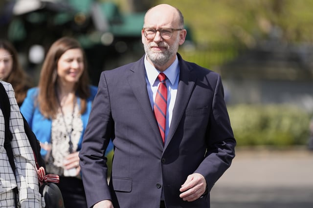 Office of Management and Budget director Russell Vought walks after a television interview at the White House, Tuesday, April 15, 2025, in Washington. (AP Photo/Alex Brandon)