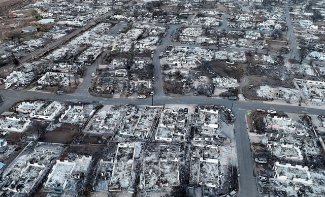 Burned cars and homes in a neighborhood was destroyed by a wildfire on August 18, 2023 in Lahaina, Hawaii.
