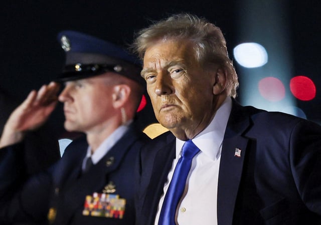 U.S. President Donald Trump looks on after disembarking from Air Force One at Palm Beach International Airport, West Palm Beach, Florida, U.S. May 1, 2025. REUTERS/Leah Millis/File Photo
