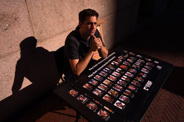 A person sits outside of Columbia University with the pictures of Israeli soldiers killed during the conflict to mark Yom HaZikaron on April 30, in New York City. Columbia University student Mohsen Mahdawi, who was taken into custody by immigration agents following his naturalization interview in Vermont, has been released on a judge&#39;s orders from detention as legal proceedings continue.