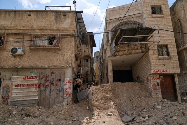 Residents of the now evacuated refugee camp of Tulkarem return to collect belongings before the destruction of their homes as Israeli forces prepare to carry out the demolition of 116 homes across the two refugee camps of the Israeli occupied West Bank city of Tulkarem, Friday, May 2, 2025. (AP Photo/Nasser Nasser)