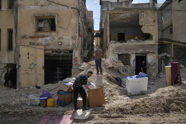 Residents of the now evacuated Palestinian refugee camp of Tulkarem return to collect belongings before the destruction of their homes as Israeli forces prepare to carry out the demolition of 116 homes across the two refugee camps of the Israeli occupied West Bank city of Tulkarem, Friday, May 2, 2025. (AP Photo/Nasser Nasser)