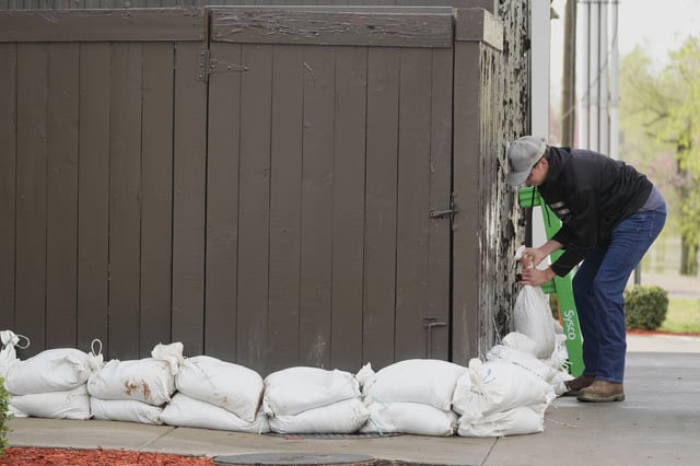 FILE - John Milt places sandbags in preparation for flooding near the banks of the Cumberland River in Clarksville Tenn., Friday, April 4, 2025. (AP Photo/George Walker IV, File)
