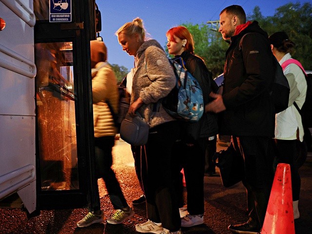 TIJUANA, MEXICO - APRIL 07: Ukrainians who are seeking asylum  board a bus at dawn on their way to the El Chaparral port of entry before entering the United Stateson April 7, 2022 in Tijuana, Mexico. Authorities have opened the El Chaparral port of entry solely for the processing of Ukrainian asylum-seekers. U.S. authorities are allowing Ukrainian refugees to enter the U.S. at the Southern border in Tijuana with permission to remain in the country on humanitarian parole for one year. Over 2,000 Ukrainians have arrived to the U.S.-Mexico border city over approximately the last 10 days. (Photo by Mario Tama/Getty Images)