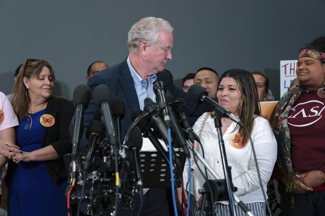 Sen. Chris Van Hollen, D-Md., gives a hug to Jennifer Vasquez Sura, the wife of Kilmar Abrego Garcia, as he speaks during a news conference upon his arrival from meeting with Abrego Garcia in El Salvador, at Washington Dulles International Airport, in Chantilly, Va., Friday, April 18, 2025. (AP Photo/Jose Luis Magana)