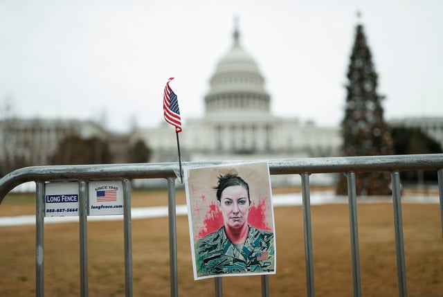 A portrait of Ashli Babbitt who was shot dead during the January 6, 2021 attack on the U.S. Capitol, hangs on a fence on the first anniversary of the event outside the Capitol, in Washington, D.C., U.S., January 6, 2022. REUTERS/Tom Brenner