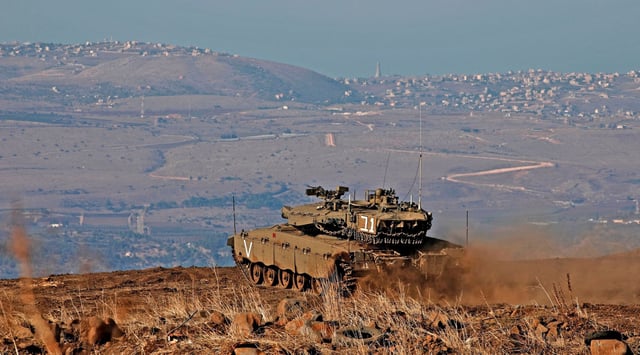 Israeli armored vehicles on the Golan Heights bear the border with Syria hours after four rockets were fired from Syria into northern Israel, Nov. 19, 2019. (Jalaa Marey/AFP via Getty Images)