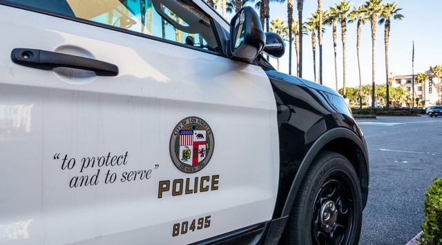 Close-up on the insignia and slogan of a LAPD vehicle. (Getty Images)