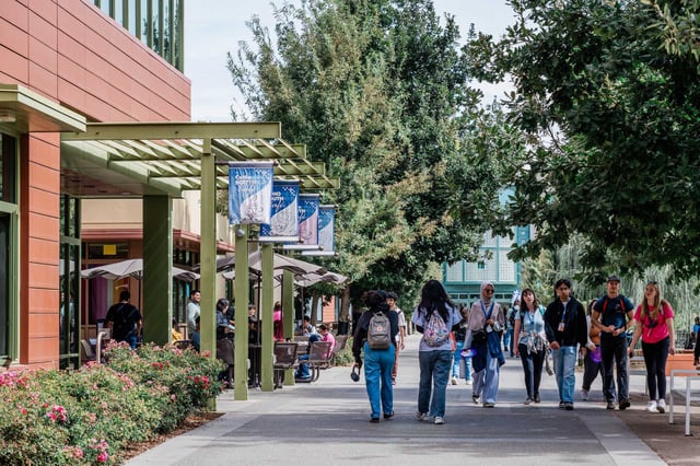 Students walk outside UC Davis Student Community Center .
