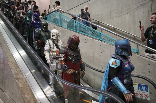 FILE - Star Wars fans in different creations of the Boba Fett uniforms attend a fan convention, the Star Wars Celebration in Chiba, near Tokyo, Friday, April 18, 2025. (AP Photo/Hiro Komae, File)