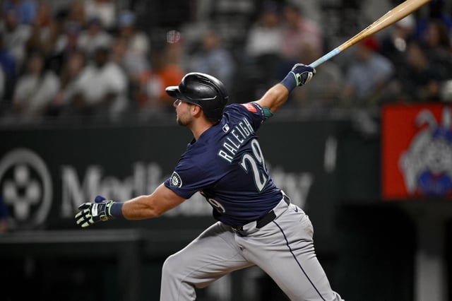 May 2, 2025; Arlington, Texas, USA; Seattle Mariners catcher Cal Raleigh (29) hits a grand slam against the Texas Rangers during the fifth inning at Globe Life Field. Jerome Miron-Imagn Images