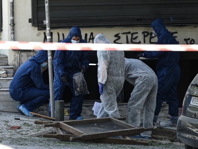 Greek police experts search for evidence after a bomb explosion in Thessaloniki on May 3, 2025. A 38-year-old woman who was seriously injured in an early-morning explosion has died from her injuries. The blast occurred in a parking lot next to a bank branch. Police spokesperson stated that investigators are working to determine whether the victim was a passerby or somehow connected to the incident. (Photo by Sakis Mitrolidis / AFP) (Photo by SAKIS MITROLIDIS/AFP via Getty Images)