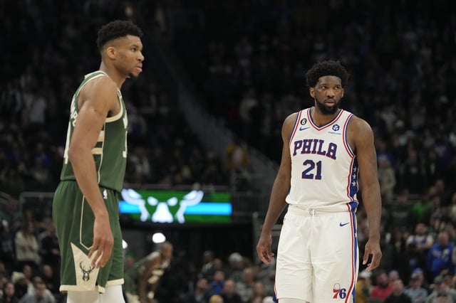 MILWAUKEE, WISCONSIN - MARCH 04: Giannis Antetokounmpo #34 of the Milwaukee Bucks and Joel Embiid #21 of the Philadelphia 76ers look on in the second half at Fiserv Forum on March 04, 2023 in Milwaukee, Wisconsin.