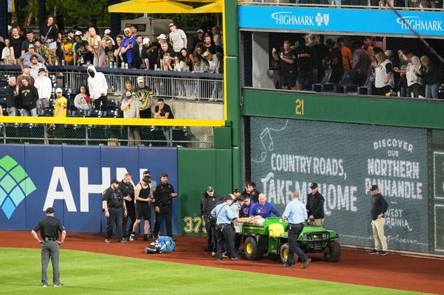 A fan is carted of the field at PNC Park after falling out of the stands during the seventh inning of a baseball game between the Pittsburgh Pirates and the Chicago Cubs in Pittsburgh on Wednesday, April 30, 2025.