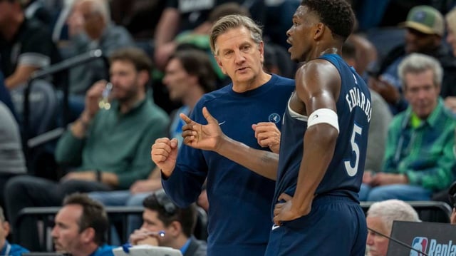 Minnesota Timberwolves head coach Chris Finch talks with Minnesota Timberwolves guard Anthony Edwards (5) during a free throw against the Charlotte Hornets in the second half at Target Center.