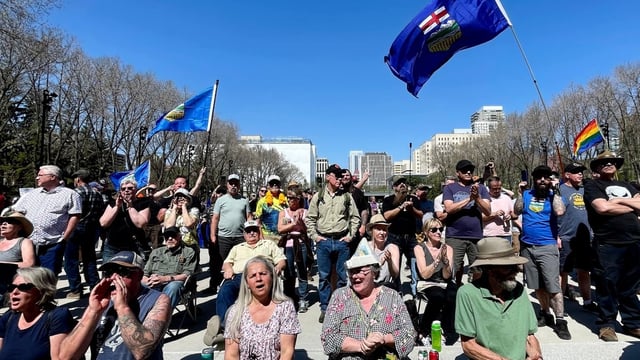 People gather in support of Alberta becoming its own nation, or the 51st state, during a rally at the Alberta Legislature Building in Edmonton on Saturday. 