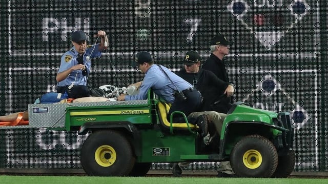 Apr 30, 2025; Pittsburgh, Pennsylvania, USA;  Stadium security and Pittsburgh Pirates medical personnel cart a fan who fell from the stands to the field to an ambulance as the Pirates batted against the Chicago Cubs during the seventh inningat PNC Park. Mandatory Credit: Charles LeClaire-Imagn Images