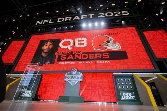 A screen shows Colorado quarterback Shedeur Sanders after being chosen by the Cleveland Browns with the 144th overall pick during the third day of the NFL football draft, Saturday, April 26, 2025, in Green Bay, Wis. (AP Photo/Jeff Roberson)