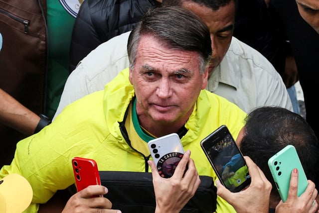 Former Brazilian President Jair Bolsonaro looks up as he greets his supporters, at a demonstration against his judicial process and to demand the amnesty of all accused of taking part in allegedly conspiring to overthrow the government, in Sao Paulo, Brazil, April 6, 2025. REUTERS/Jorge Silva/File Photo