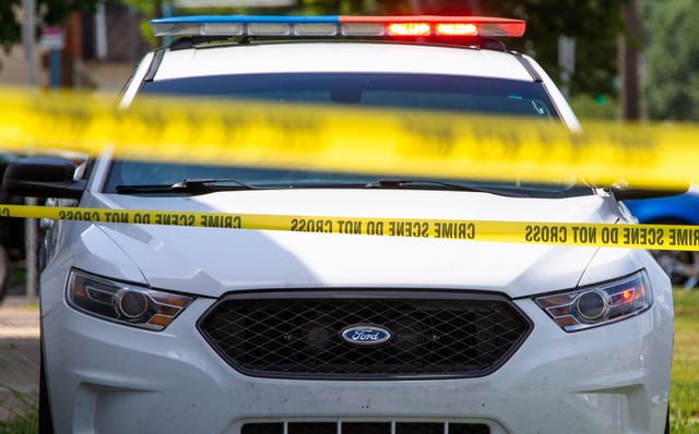 Crime scene tape near a squad car.

Police File Photo