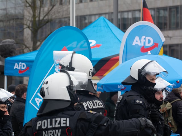 Police protect the participants of the AFD rally for the upcoming election in Oberbilk market in Duesseldorf, Germany, on February 15, 2025, as hundreds of counter-protesters protest against AFD (Photo by Ying Tang/NurPhoto via Getty Images).