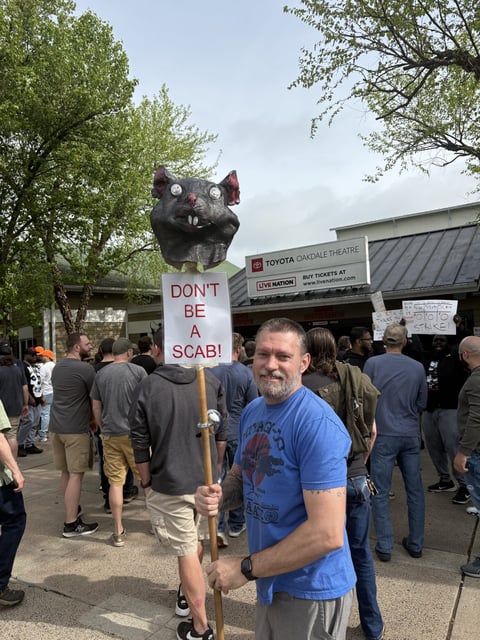 Driton Ahmetovic, a union member from the East Hartford power plant, stands outside of the Oakdale Theater in Wallingford on Sunday morning.