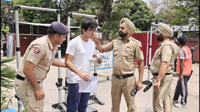 A student being frisked before appearing for the National Eligibility-cum-Entrance Test (NEET) - UG exam at GMSSS, Sector 22, on Sunday. (Keshav Singh/HT)