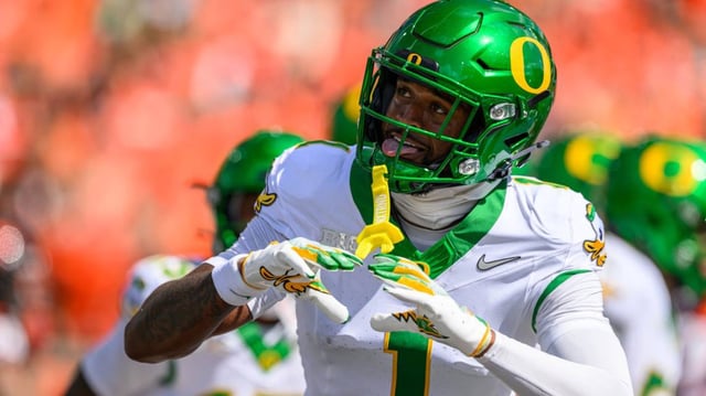 College football fans react to Oregon Ducks star Traeshon Holden getting ejected for spitting on an Ohio State Buckeyes player.