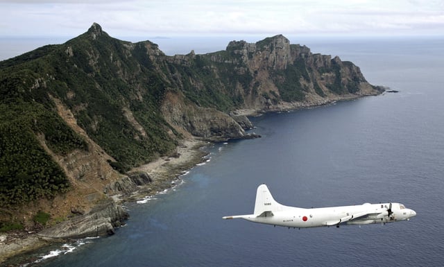A Japanese patrol aircraft flies over the Senkaku Islands in the East China Sea on October 13, 2011.