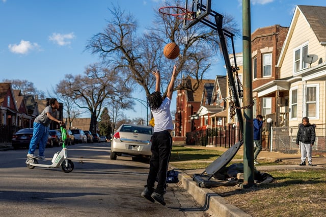 Keyon plays basketball with his cousins near the intersection of South Laflin and West 63rd streets during the first week of spring in the West Englewood community on March 24, 2025, in Chicago. (Armando L. Sanchez/Chicago Tribune)