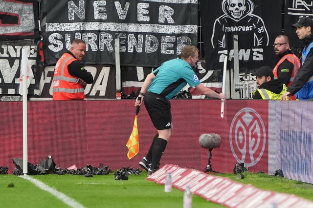Frankfurter Fans bewarfen den Schiri-Assistent Robert Wessel, der eine Fahnenstange wegräumt.