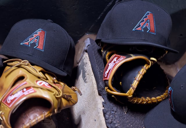 A detailed view of the Rawlings baseball gloves and hats belonging to Jake Lamb #22 and Paul Goldschmidt #44 of the Arizona Diamondbacks sitting on the dugout steps during the game against the San Francisco Giants at AT&amp;T Park on April 19, 2016 in San Francisco, California.