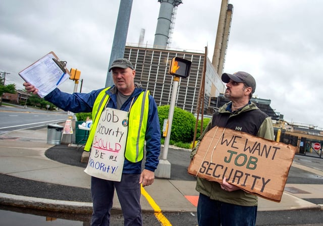 Pratt & Whitney employees hold signs while picketing at the Main Street entrance in East Hartford, Conn., on the first day of their strike, Monday, May 5, 2025. (Aaron Flaum/Hartford Courant via AP)