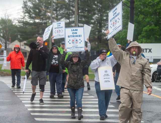 Pratt &amp; Whitney employees hold signs while picketing at the Silver Lane entrance in East Hartford on Monday. the first day of their strike. (Aaron Flaum/Hartford Courant)