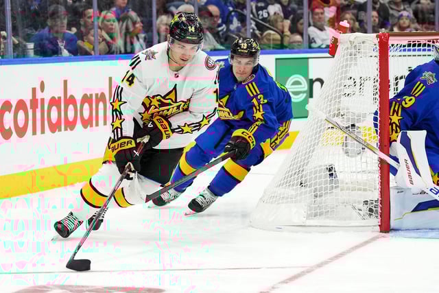Feb 3, 2024; Toronto, Ontario, CAN; Team McDavid center Nick Suzuki (14) of the Montreal Canadiens moves the puck against Team Matthews center Mathew Barzal (13) of the New York Islanders in the 2024 NHL All-Star Game at Scotiabank Arena. Mandatory Credit: Nick Turchiaro-USA TODAY Sports/File Photo