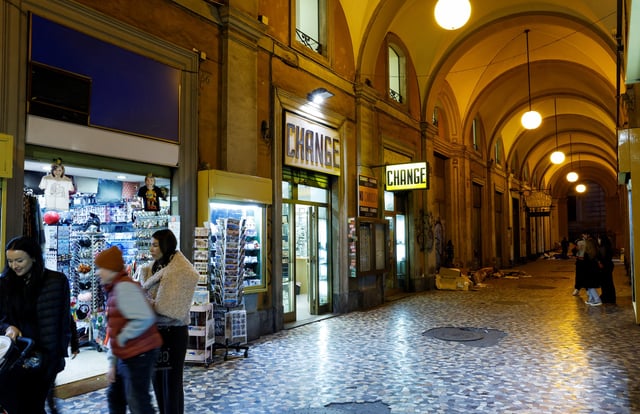 People walk next to shops in downtown Rome, Italy, December 2, 2023. REUTERS/Remo Casilli/File Photo