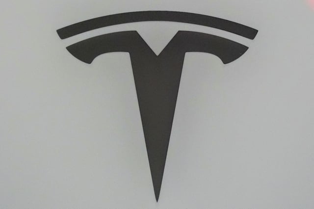 The Tesla logo is seen at the Everything Electric, the Home Energy & Electric Vehicle Show, in London, Britain, April 16, 2025. REUTERS/Maja Smiejkowska/File Photo