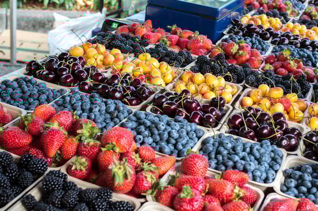 A selection of organic berries and cherries at a farmer&#39;s market.