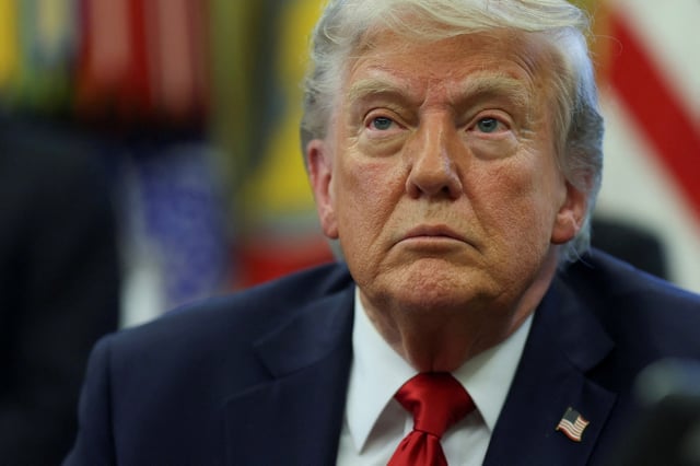 U.S. President Donald Trump looks on, as he signs executive orders in the Oval Office at the White House in Washington, D.C., U.S., April 23, 2025. REUTERS/Leah Millis/File Photo