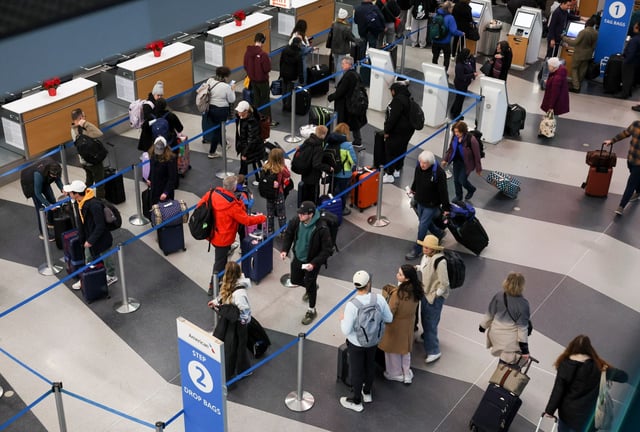 People wait in line at check-in counters at O&#39;Hare International Airport on Dec. 23, 2024. (Eileen T. Meslar/Chicago Tribune)