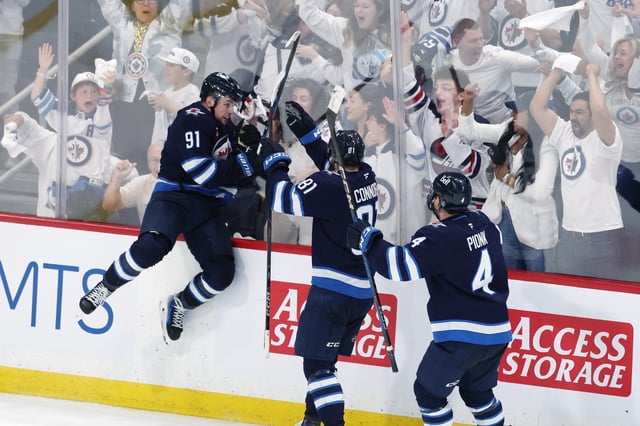 May 4, 2025; Winnipeg, Manitoba, CAN; Winnipeg Jets center Cole Perfetti (91) celebrates after his goal against the St. Louis Blues with teammates left wing Kyle Connor (81) and defenseman Neal Pionk (4) in the third period in game seven of the first round of the 2025 Stanley Cup Playoffs at Canada Life Centre. Mandatory Credit: James Carey Lauder-Imagn Images