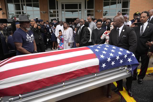 FILE - Friends and family of Roger Fortson watch as his casket leaves for the cemetery at New Birth Missionary Baptist Church on May 17, 2024, in Stonecrest, Ga. (AP Photo/Brynn Anderson, File)