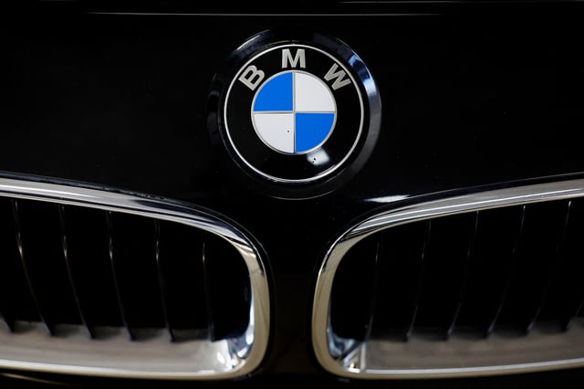 A logo of BMW is seen inside a car dealer in Nijmegen, Netherlands February 26, 2025. REUTERS/Piroschka van de Wouw/File Photo