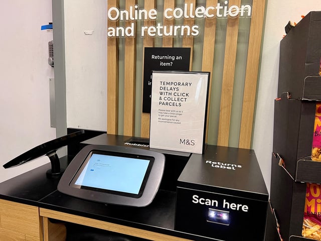 A sign warning of temporary delays with Click & Collect parcels stands at an M&S Food Hall in London, Britain, April 30, 2025. REUTERS/Suzanne Plunkett/File Photo