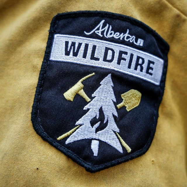 A shoulder patch of the Alberta Wildfire service is pictured in Fort McMurray, Alta., Thursday, May 16, 2024. A wildfire burning northeast of Edmonton has forced residents to immediately flee the area. THE CANADIAN PRESS/Jeff McIntosh