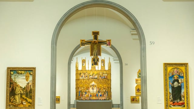 For the first time in the gallery a picture has been hung from the ceiling in an approximation of how Segna di Bonaventura’s Crucifix would originally have been shown. Below is Jacopo di Cione’s San Pier Maggiore altarpiece