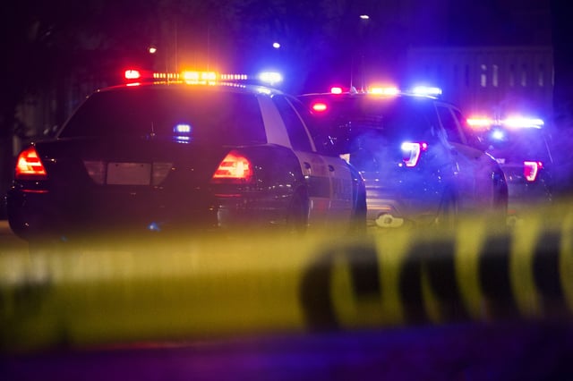 Stock image/file photo: Police cars behind a cordon.
