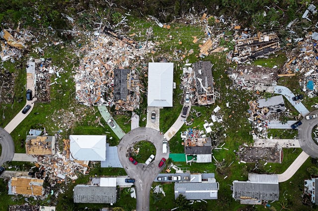 Aerial view of destroyed houses in Port St Lucie, Florida, after a tornado hit the area and caused severe damage as Hurricane Milton swept through Florida on October 11, 2024. The death toll from Hurricane Milton rose to at least 16 on October 11, 2024, officials in Florida said, as residents began the painful process of piecing their lives and homes back together. Nearly 2.5 million households and businesses were still without power, and some areas in the path cut through the Sunshine State by the monster storm from the Gulf of Mexico to the Atlantic Ocean remained flooded. (Photo by Miguel J. Rodriguez Carrillo / AFP) (Photo by MIGUEL J. RODRIGUEZ CARRILLO/AFP via Getty Images)
