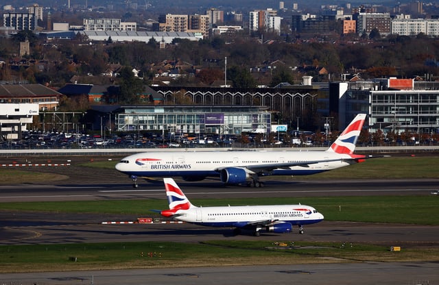 A British Airways Boeing 777 passes a British Airways Airbus as it takes off from Heathrow Airport, in London, Britain, November 28, 2023.  REUTERS/Peter Nicholls/File Photo