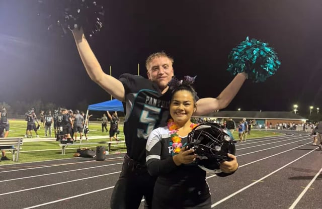 Michael Bosworth Jr. and his girlfriend, Malinda Garcia, pose on the Massaponax High School track after a football game in 2024. (Courtesy of Malinda Garcia)